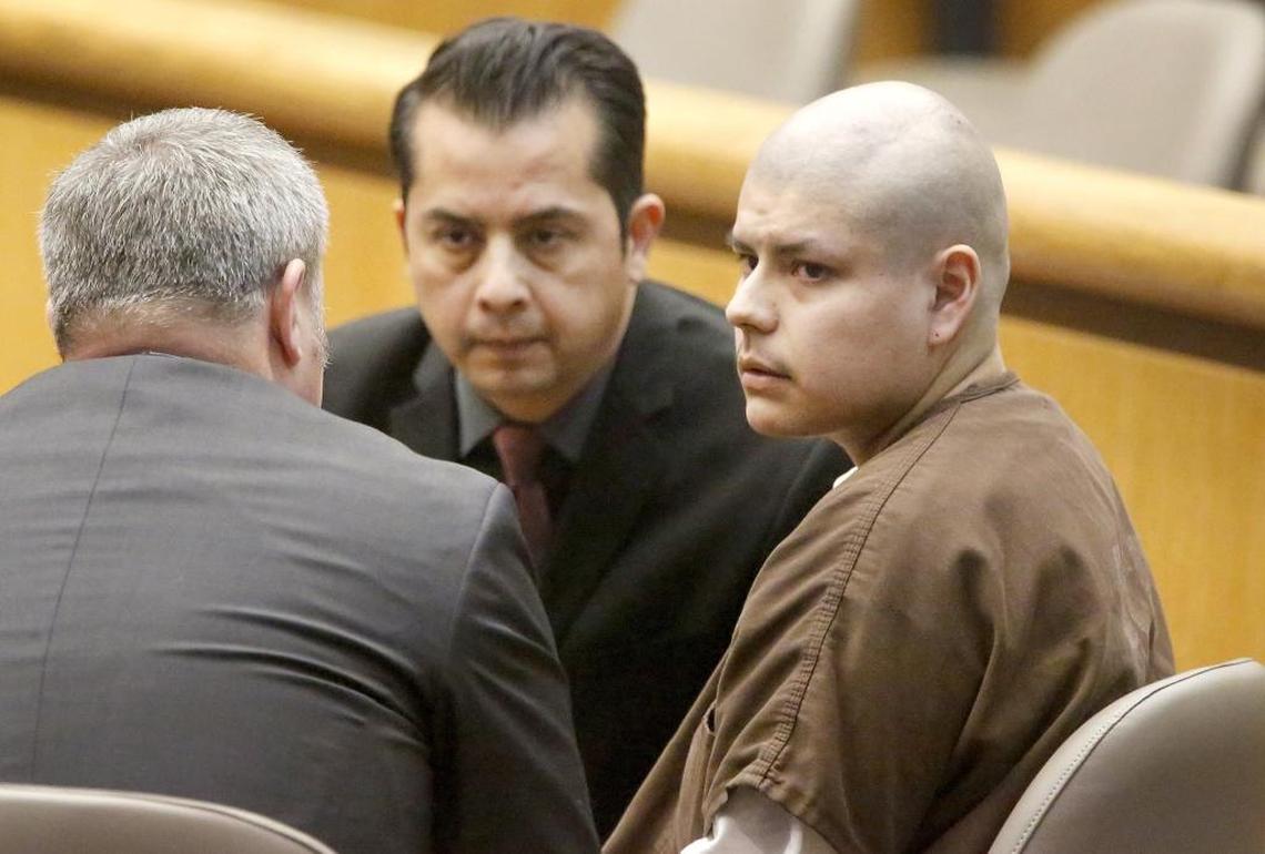 Convicted triple murderer Francisco Resendez Miranda confers with his lawyer Shane Silverthorn, left, before choosing to speak during his sentencing in Benton County Superior Court in 2015. Court interpreter Frank Rojas, middle, helps with the conversation.