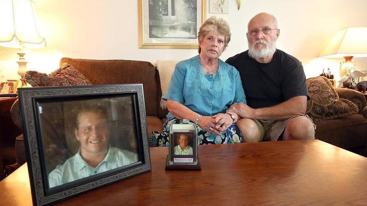 Diane and Alan Campbell sit in the living of their Richland home near photos of their grandson, Mitchell Campbell, they displayed at his funeral. The 26-year-old man died last year while an inmate at the Franklin County Jail.