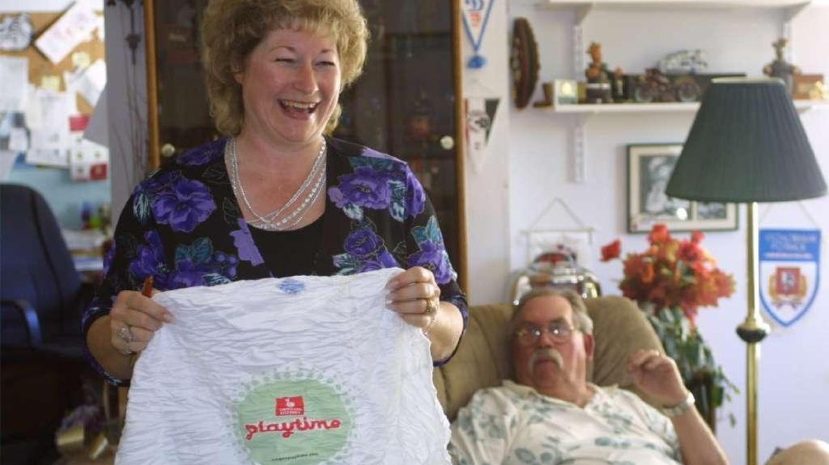In 2003 Donna Anderson held up the shirt she was given by lottery officials when she won an $18.2 million lottery. Her husband, former Hermiston Police Chief Andy Anderson, right, died in 2008.