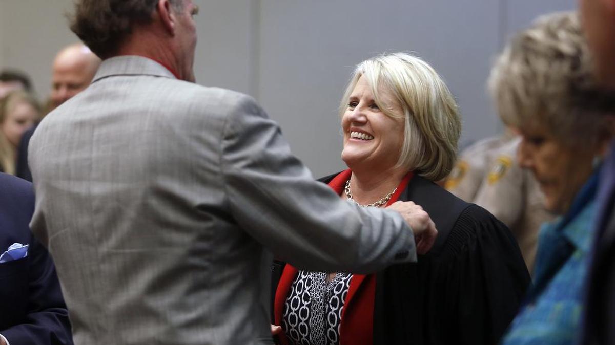 
Jackie Shea Brown hugs her husband Russ Brown after being sworn as the seventh Superior Court judge during a ceremony at the Benton County Justice Center in Kennewick. Shea Brown, a Richland family and criminal law attorney, was appointed earlier this month by Gov. Jay Inslee to fill a newly created seventh position on the bench. 
