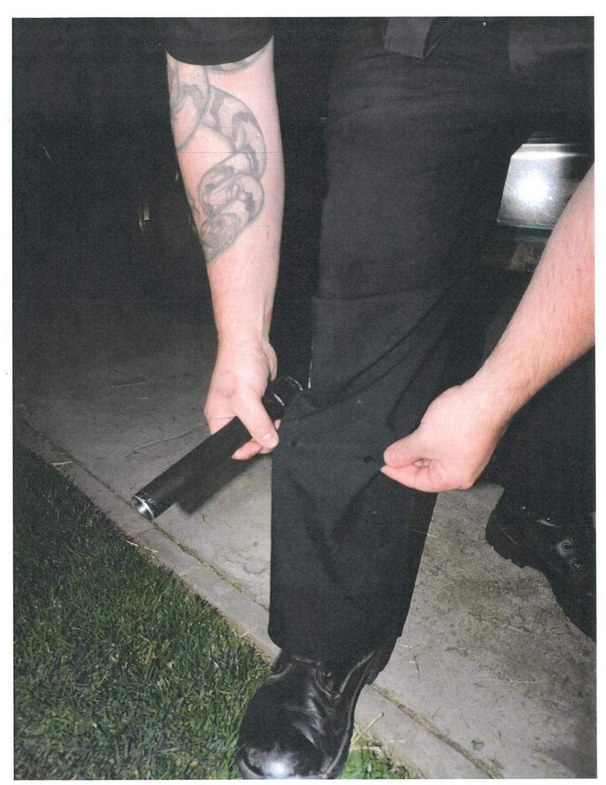 Pasco police Officer John D’Aquila shows a hole in his pant leg after the shooting in the basement of a South Ninth Avenue home. Police reports say the hole was made by a bullet from Edwin Espejo’s Ruger P90DC pistol.
