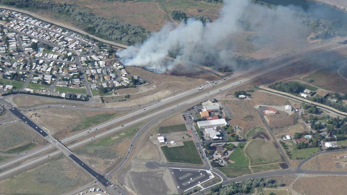 Smoke billows from a fire burning between the Yakima River and Hill’s Mobile Home Park in Richland on Sunday afternoon. About 20 acres were burned but not homes were damaged, a fire official said.