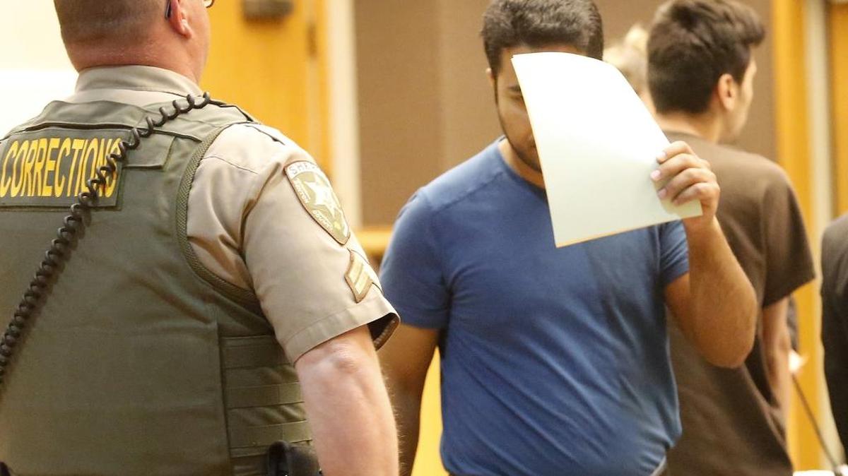 Yasir M. Majeed, 35, covered his face during a court hearing earlier this month in Benton County Superior Court. He now has an Oct. 9 trial date on charges of attempted second-degree rape of a child and commercial sex abuse of a minor.