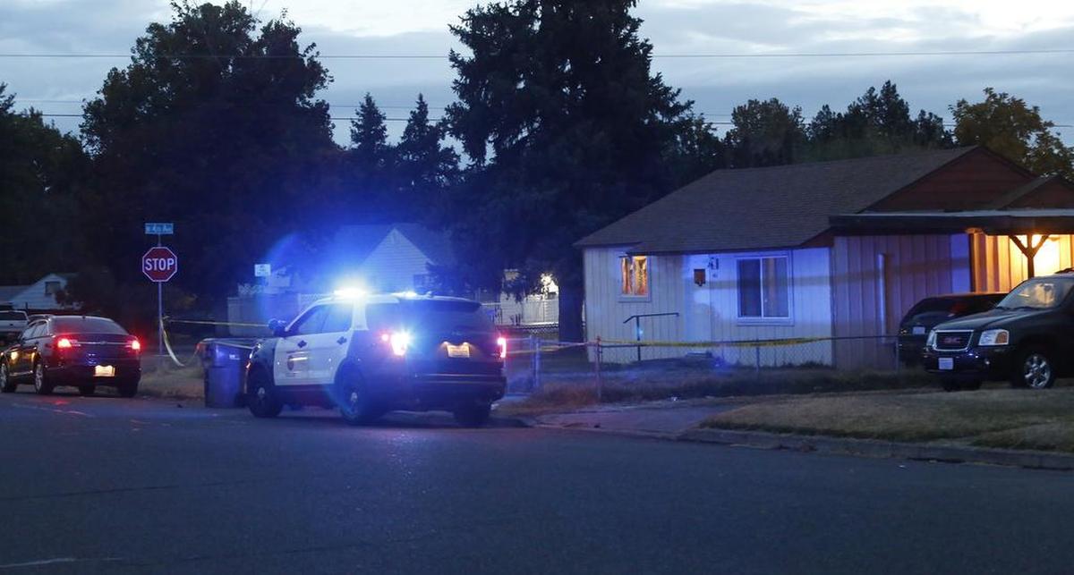 Kennewick police vehicles park outside 401 S. Yelm St. during the 2018 homicide investigation at the home following the early-morning shooting.