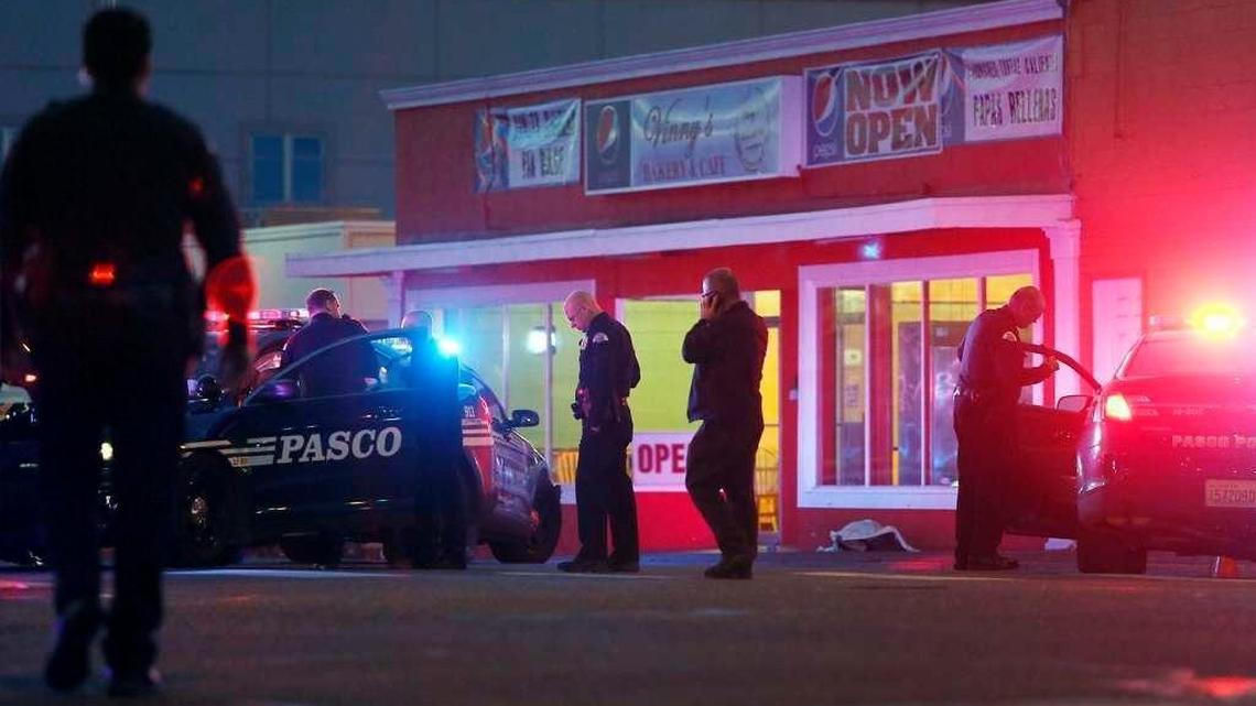 Pasco police officers gather outside of Vinny's Bakery and Cafe on 10th Avenue and Lewis Street in Pasco on Feb. 10, following the shooting death of Antonio Zambrano-Montes by Pasco police officers.