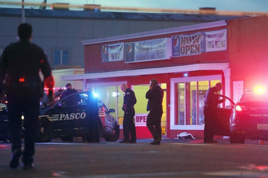 Pasco police gather outside of Vinny's Bakery & Cafe on 10th Avenue and Lewis Street in Pasco on Feb. 10, 2015, after three officers shot Antonio Zambrano-Montes.
