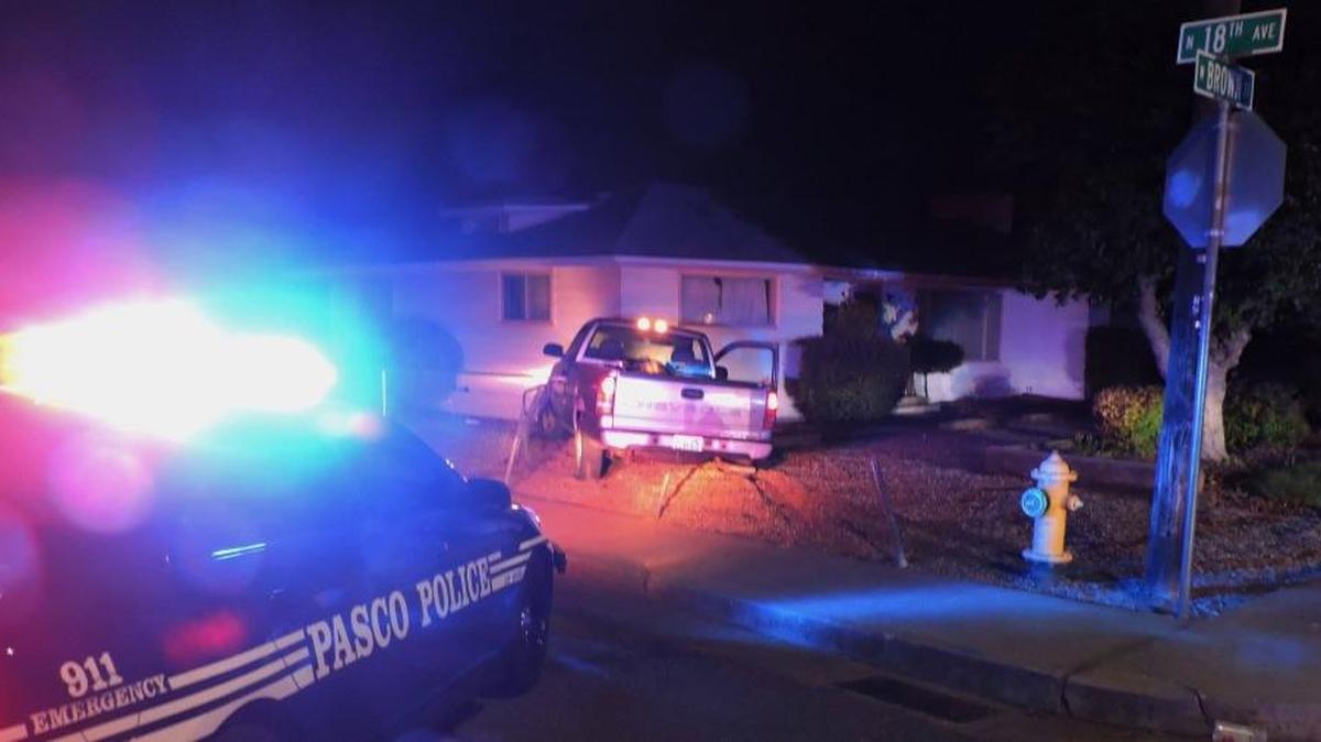 Pasco police officers are looking for two males who fled from a stolen truck after crashing it into a home.