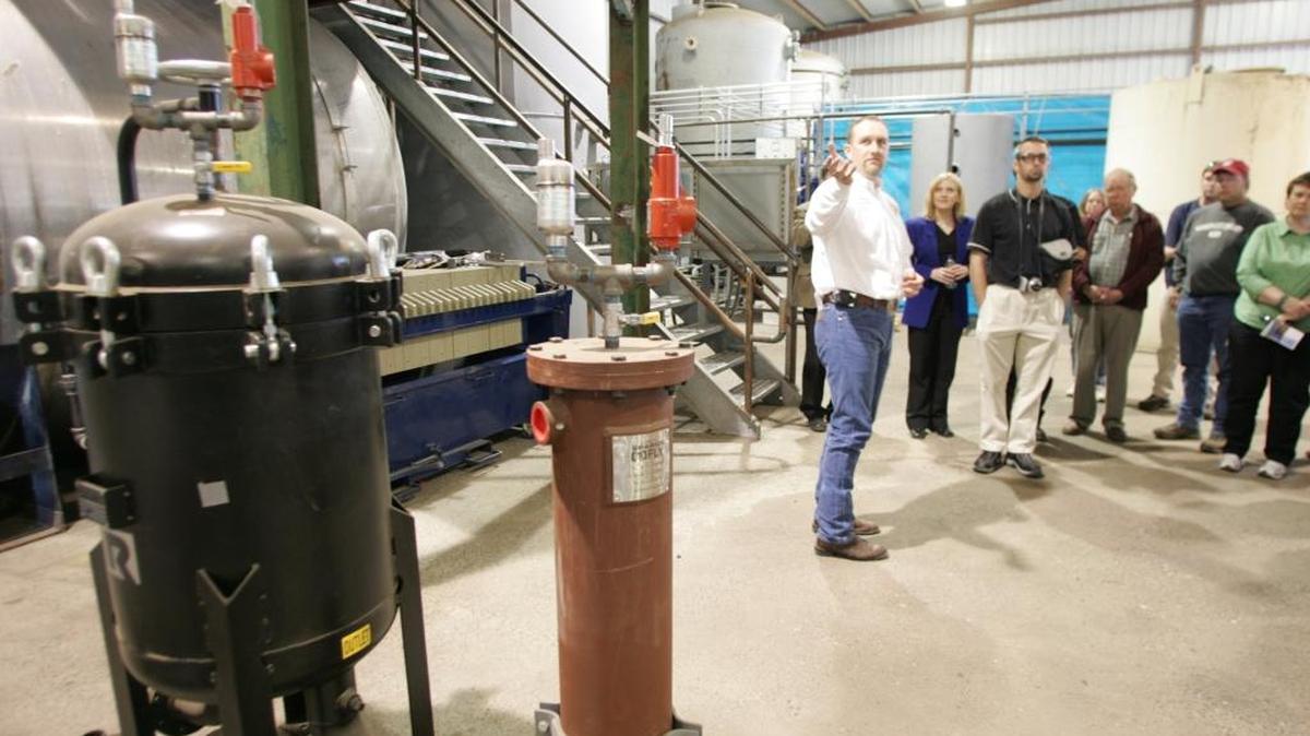 Scott C. Johnson, president of the Pasco-based Gen-X Energy Group, was sentenced Thursday to eight years in federal prison for bilking the government out of millions of dollars in renewable energy tax credits. Johnson, left, was photographed in 2007 during a tour at his Burbank biodiesel facility, two years before the plant was damaged in a suspicious fire.