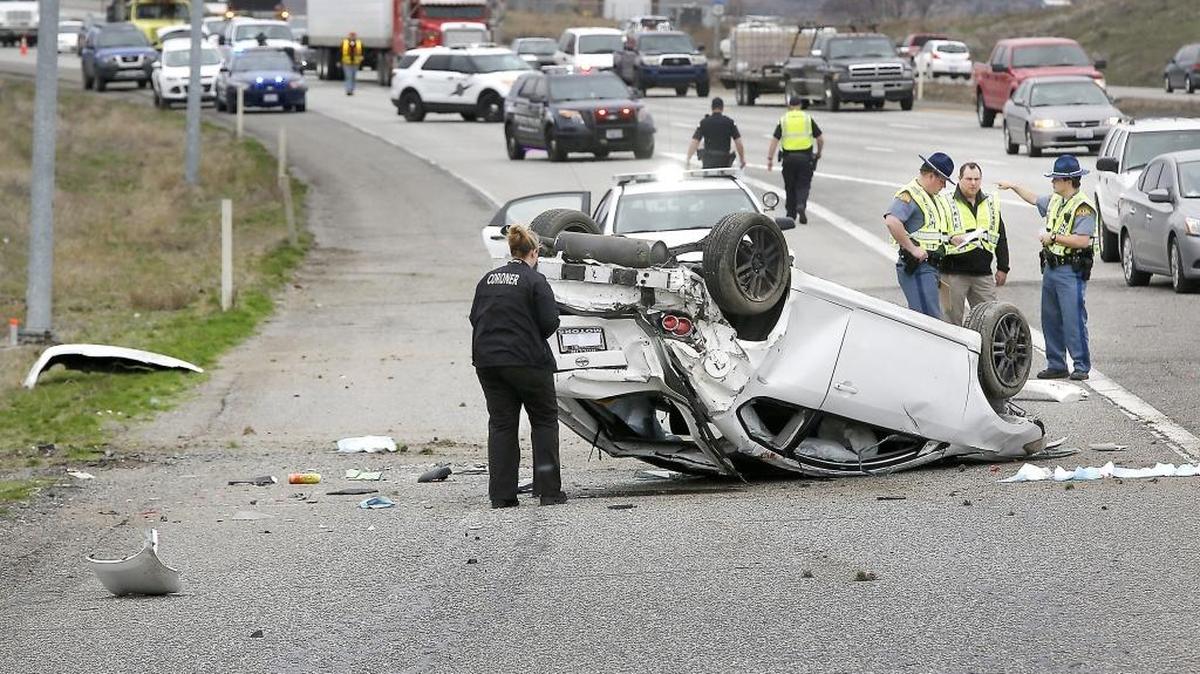 Law enforcement and officials from the Franklin County Coroner’s office investigate Friday’s fatal collision on Interstate 182 at the Broadmoor Boulevard exit ramp in Pasco. One male died at the scene after being thrown from the overturned vehicle. The incident is still under investigation.