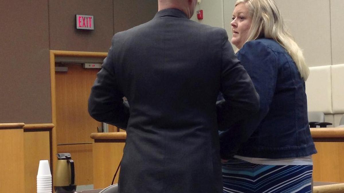 Mindy Stoker talks with her attorney, Ryan Earl, before pleading guilty Monday in Benton County Superior Court.