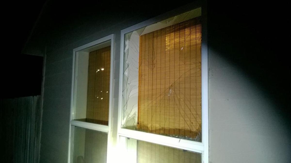 West Richland police say a woman broke this window at her former boyfriend’s home with a rock before damaging his truck with a shovel.