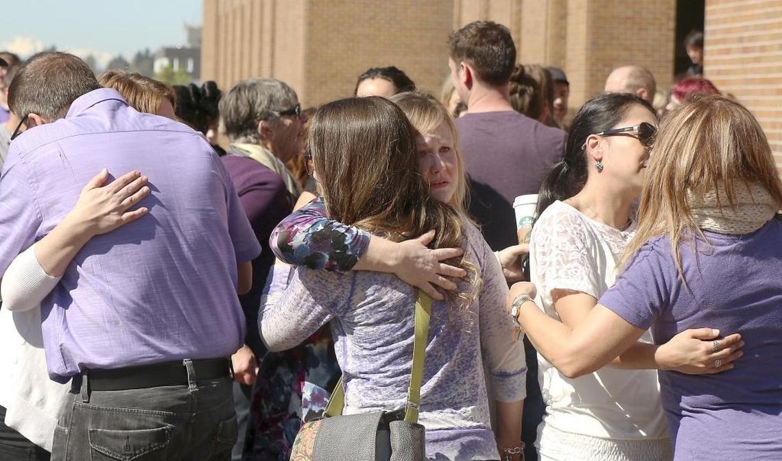 Friends and family members of Katy Straalsund embrace, mourning and celebrating the UW student's life during her vigil in the University's Red Square in March 2016.