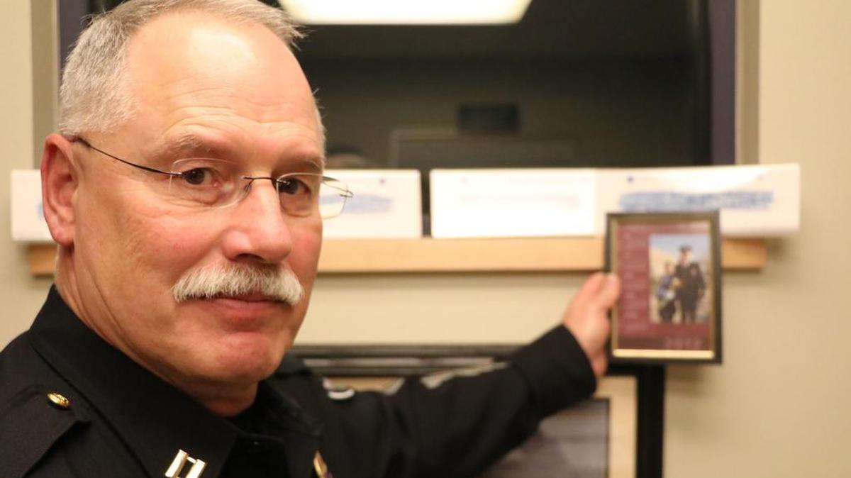 Richland police Capt. Mike Cobb holds a picture of Franny Lowry, daughter of Tacoma police officer Bill Lowry, below a memorial rubbing of her father’s name. Cobb was friends with Bill Lowry when he was killed in the line of duty in 1997.
