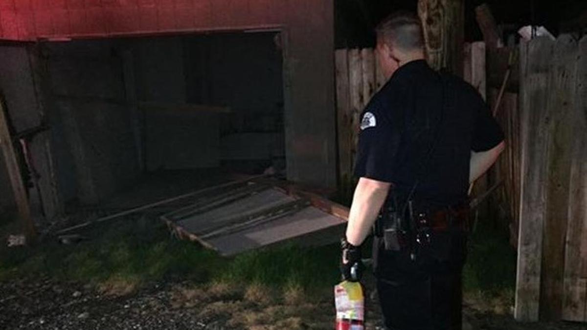 Pasco police Officer Joe Mullen used a fire extinguisher to put out a garage fire Friday morning.