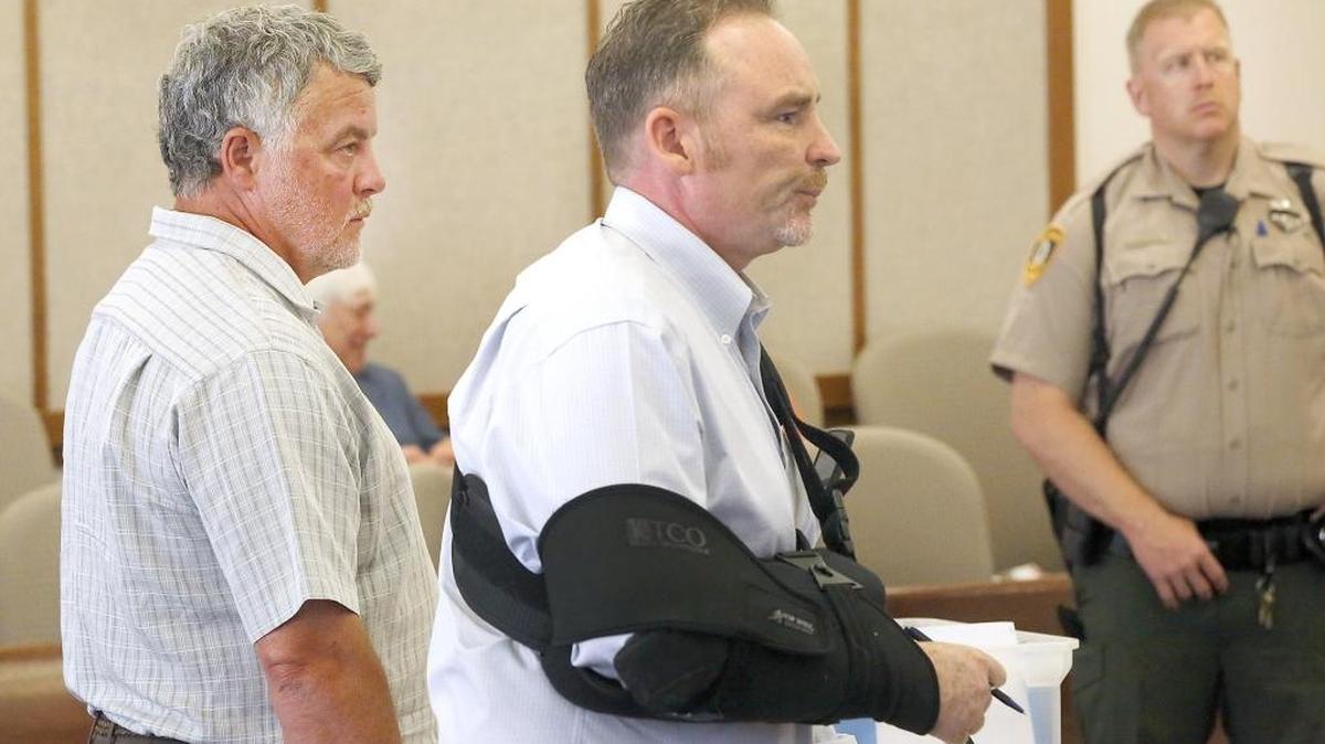Michael Lee Brooks, 53, left, who has been charged with first-degree theft and 10 counts of money laundering, appeared recently in Franklin County Superior Court with his defense attorney John Jensen, center.