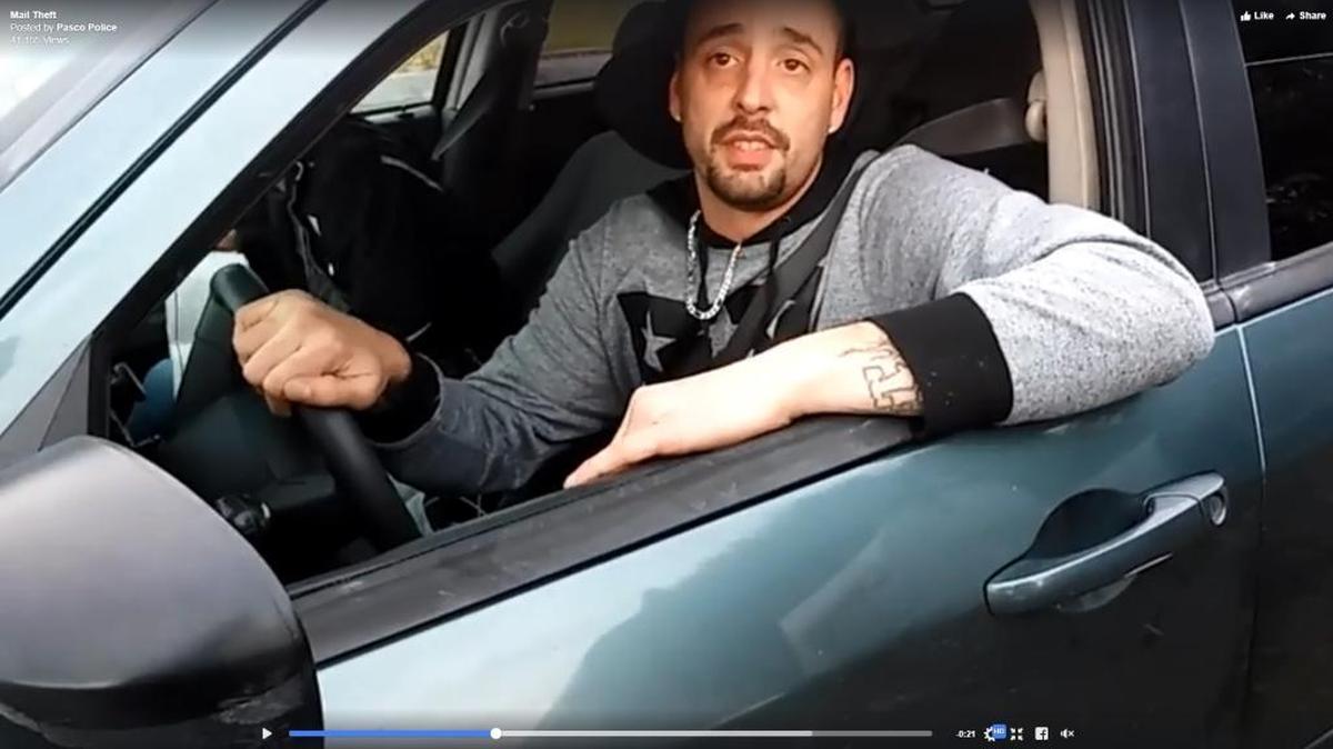 A video of an alleged mail thief went viral after a resident caught a man pawing through his mail