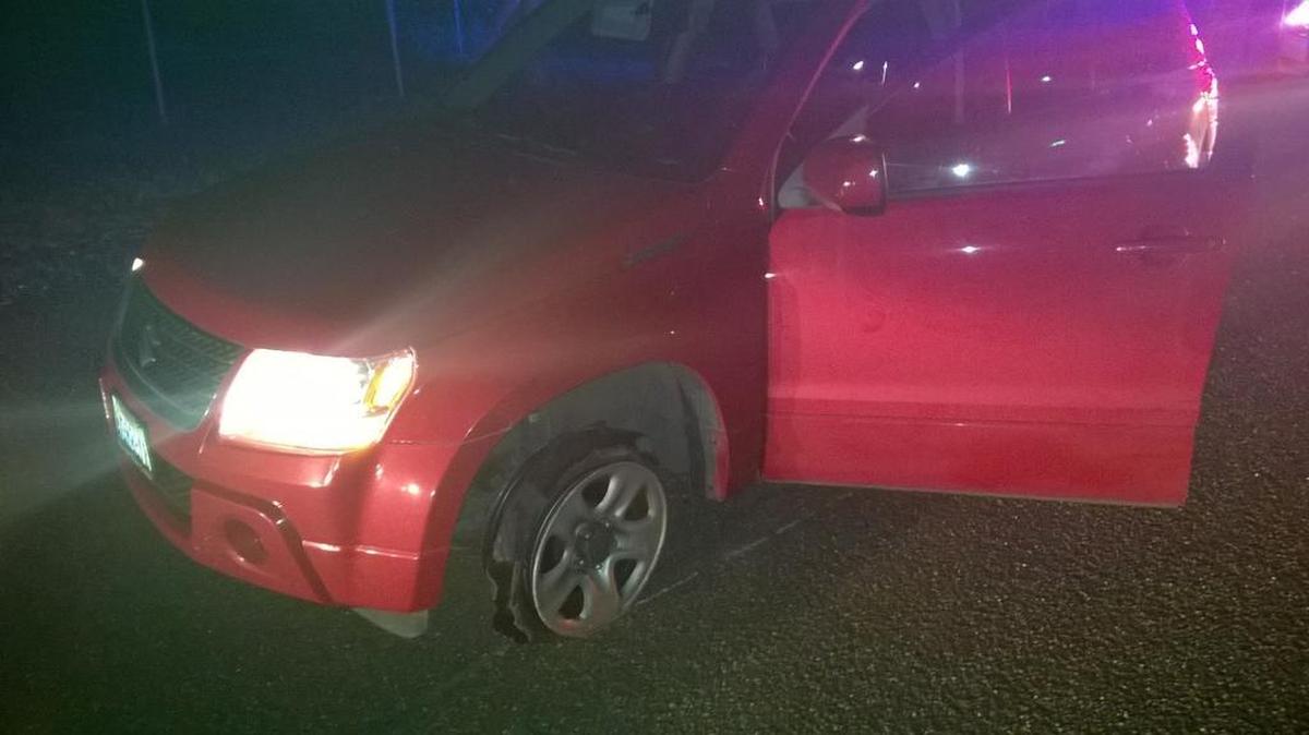 This red Suzuki SUV had all its tires punctured by a spike strip on Highway 240 after its driver led police on a chase through the Tri-Cities early Thursday morning.