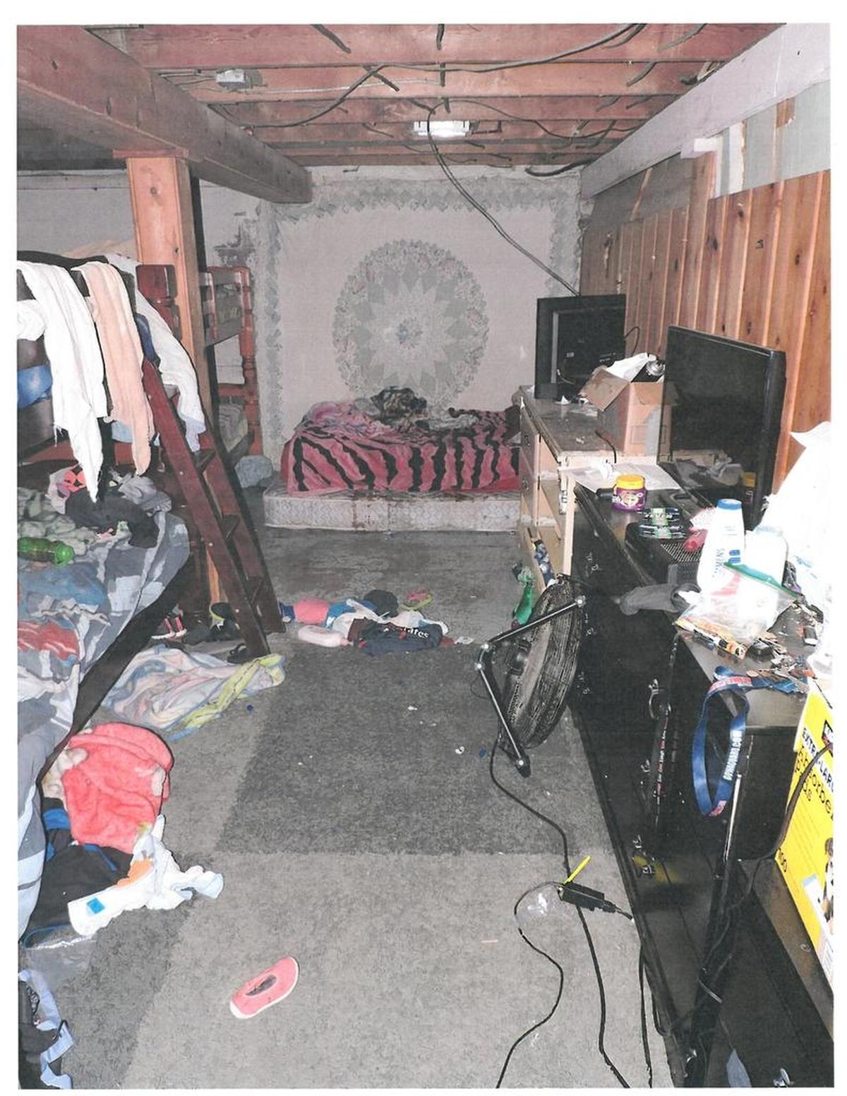 Pasco officers described the basement room where they found Edwin Espejo on Sept. 16 as “cluttered and poorly lit.” Espejo was on the mattress against the far wall, as seen from the perspective of responding officers.