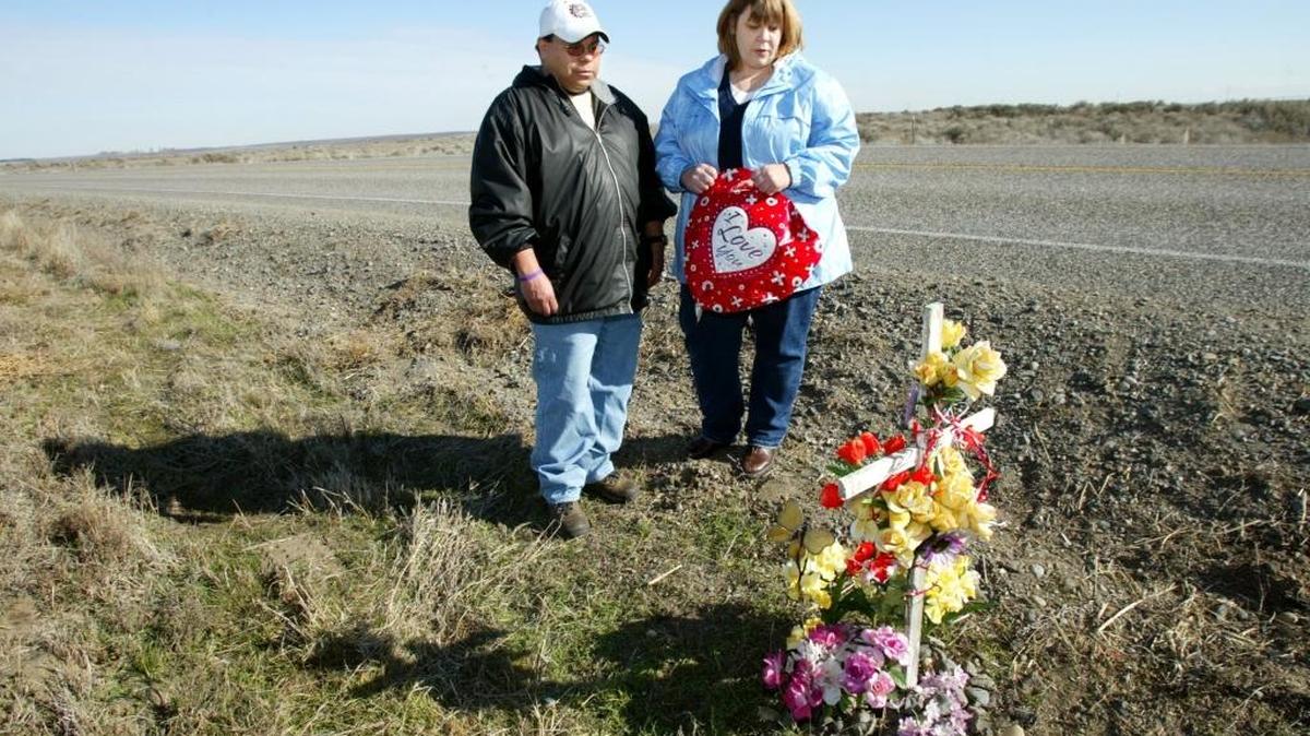 
Christine Pelayo, right, and her friend Noe Rodriguez pause for a quiet moment in 2005 at the roadside memorial for Pelayo’s daughter on Taylor Flats Road north of Interstate 182 in Franklin County. Anna Pelayo, then 13, was discovered there seven years earlier with a bullet wound to the head. 
