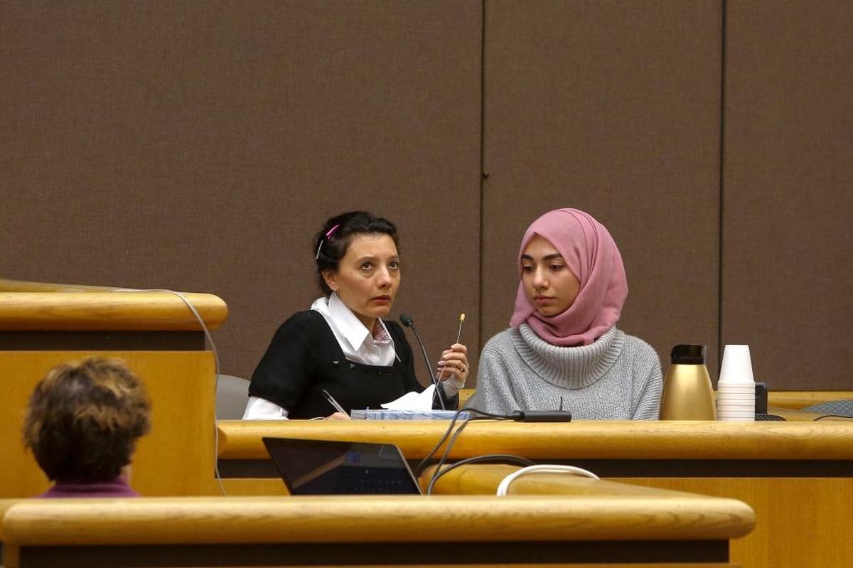 Aya Sweidan, right, testifies against her father, Abdul Rahman Sweidan, during his attempted murder trial Wednesday in Benton County Superior Court. The 19-year-old Kennewick woman is assisted by Arabic-speaking court interpreter Diana Noman on the left.