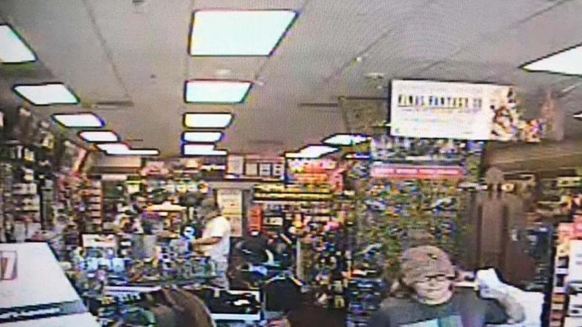 An accomplice in a purse snatching case leaves a Gamestop store Aug. 18.