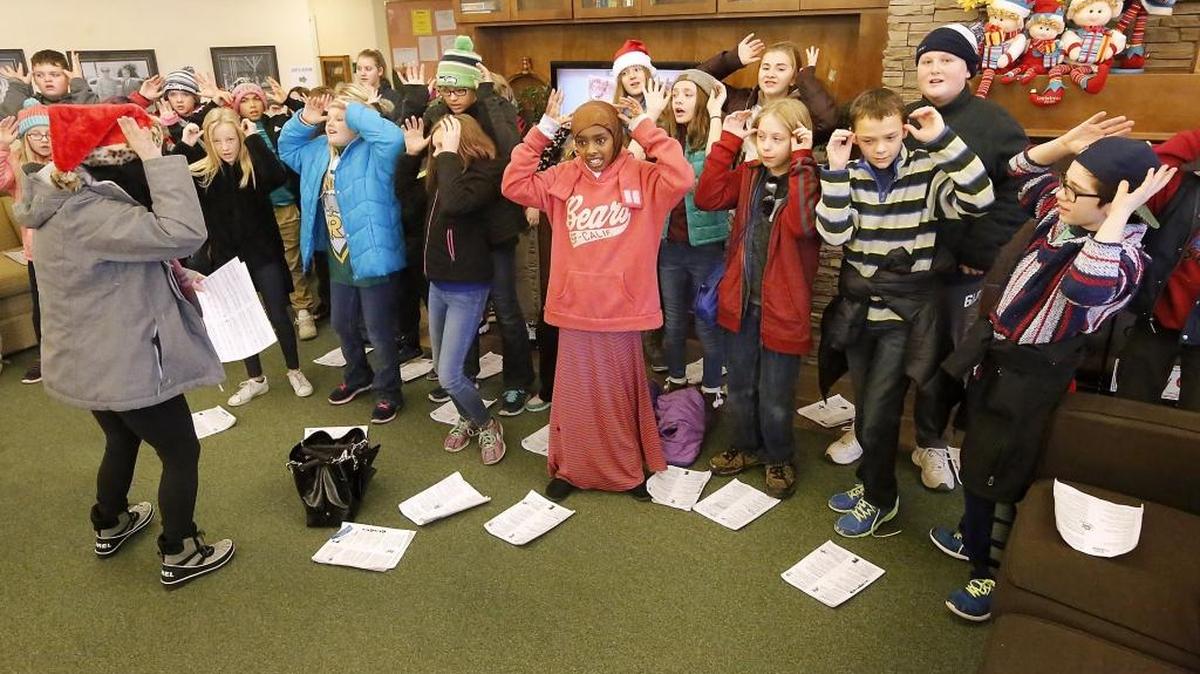 Maxine Townson, choir director at Chief Joseph Middle School, leads her sixth-grade students in a Christmas carol during Monday’s visit to Guardian Angel Homes in Richland. The visits encourage the Richland students to give back to the community by offering “an opportunity to encourage others,” she said. Watch a video at: tricityherald.com/video.
