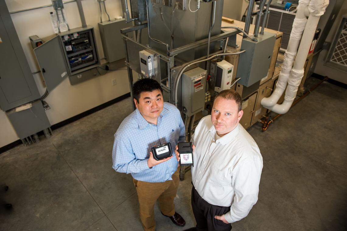 PNNL cybersecurity experts Eric Choi, left, and Thomas Edgar helped develop SerialTap, an inexpensive, compact device that connects older systems, such as those found in many hydroelectric facilities, to advanced networks and cybersecurity tools.
