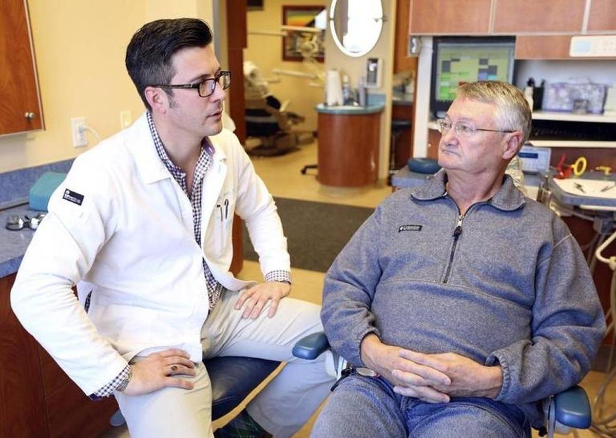 Dr. Bart Roach of Three Rivers Dental with a patient in his Kennewick office last year.