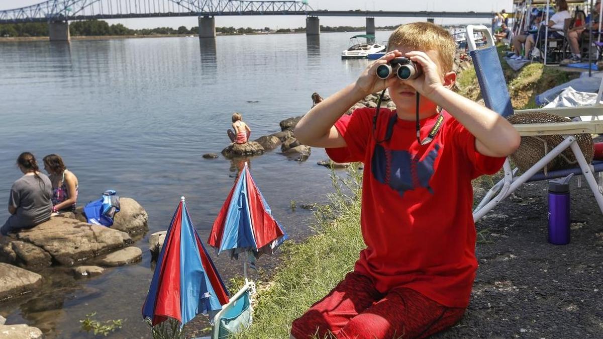 Cash Melville, 8, watches closely through his binoculars as the hydroplanes qualify during the Tri-City Water Follies on Friday. It was Melville’s first year attending Follies. Melville was accompanied by his grandmother, Lynn Dossett, of West Richland.