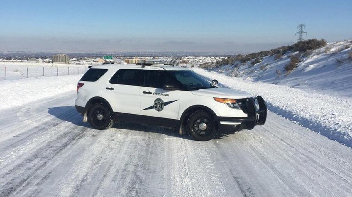 A Washington State Patrol SUV parked on an icy road.