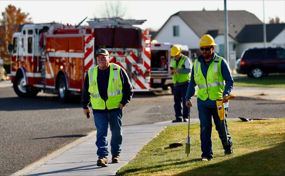 Cascade Natural Gas workers search Friday morning for the turn-off valve to stop a possible gas leak on the 5000 block of Wrigley Drive.