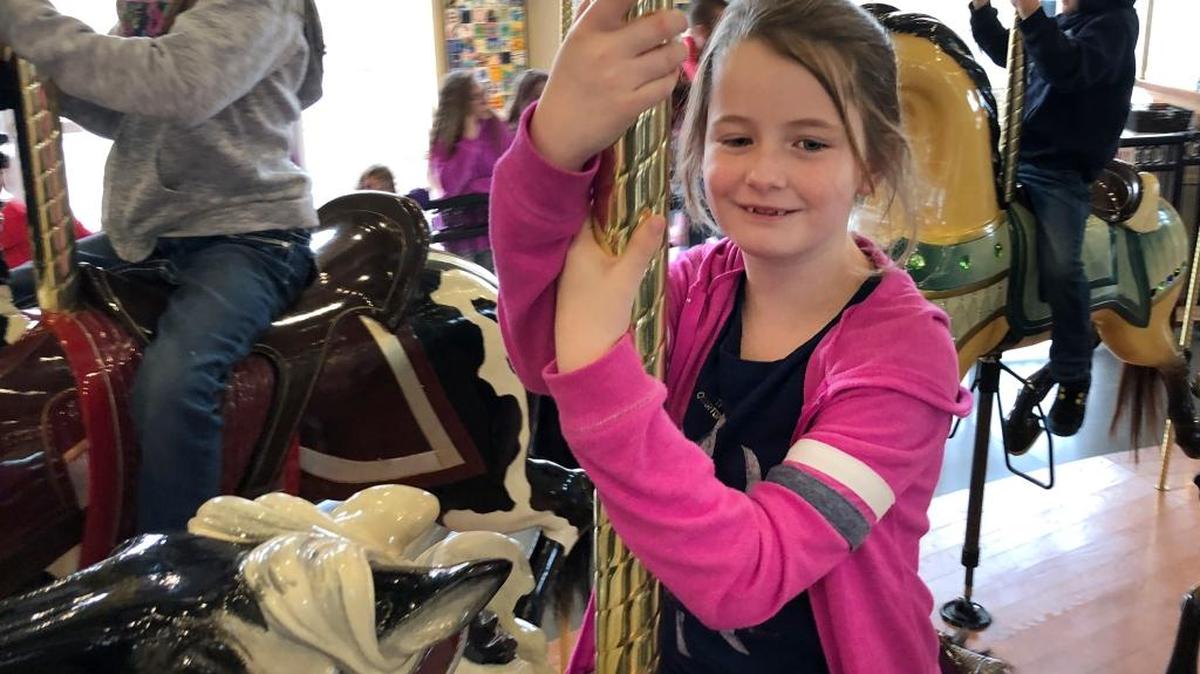 Jada Bowman, 9, grins as she rides on the Gesa Carousel of Dreams on Saturday. The Moses Lake girl was the 500,000th rider at the Kennewick attraction, which opened Labor Day Weekend in 2014. Bowman, who was celebrating her birthday, and her parents Kyra and Daniel Bowman received $500 in prizes plus 100 ride tokens.