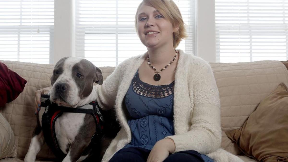 Taylor Smith, 20, a Tri-Cities native, sits with her service dog, Rocco, at her grandparents’ house in Finley. Smith was recently discharged from the Marine Corps.