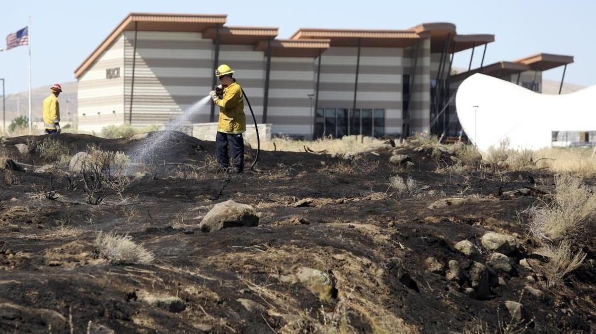 Firefighters with the Richland Fire Department extinguish a small fire that covered about half an acre of dry brush at the west end of Columbia Park near the Reach museum Wednesday. The cause of the fire is still under investigation.