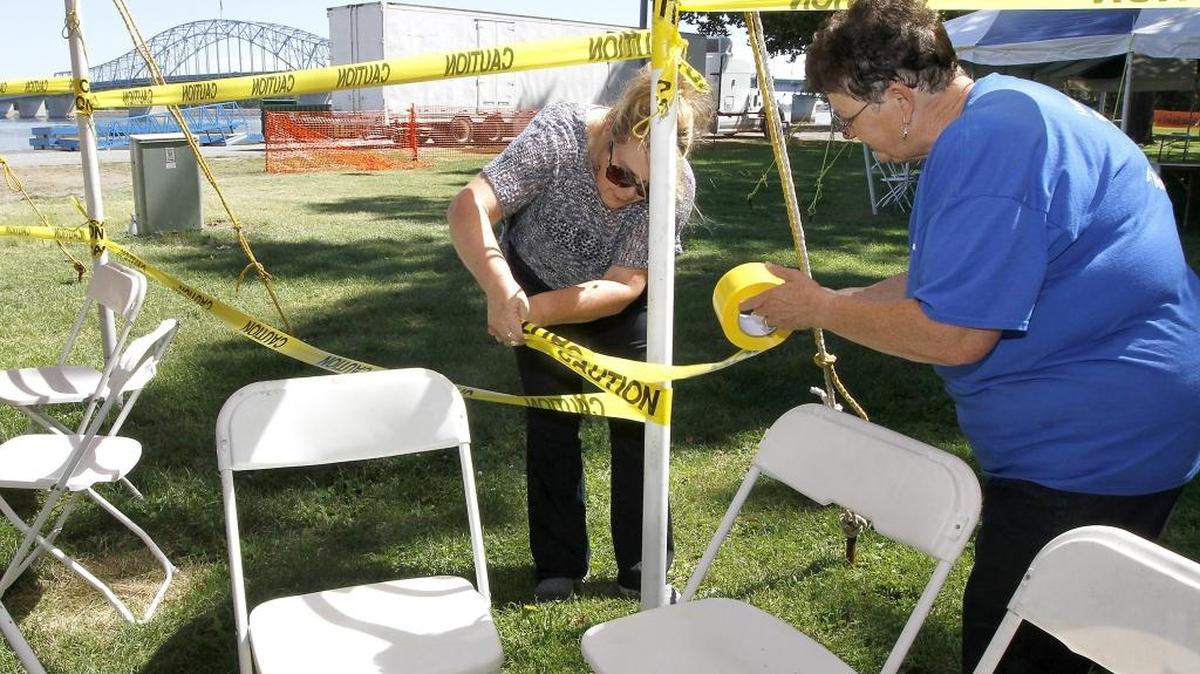 Volunteers Gail Andreas, left, and Pat Burden string caution tape around the open end of a tent they were helping set up Friday for today’s Convoy of Hope event. Organizers say about 1,500 volunteers are lined up to help an expected 7,500 people at the free humanitarian event in the east end of Columbia Park. About $1 million in goods and services will be given away. There are 14 large tents set up to shade the participants and volunteers. Watch a video at tricityherald.com/video