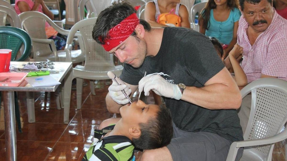 Bart Roach, owner of Three Rivers Dental in Kennewick, treats a child in Guatemala during a visit earlier this year. Roach is returning to the Central American country in November and is raising money for equipment.