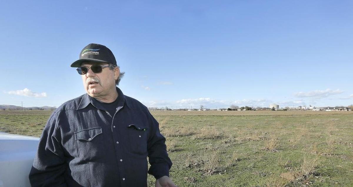 Gene Mercer, owns land in the Finley area where cannabis is cultivated but he says the land is zoned for heavy industrial use. Mercer is standing near a crop circle near the intersection of Piert Road and SR397 he leases for traditional agriculture plantings but situated not far from chemical producing plants.