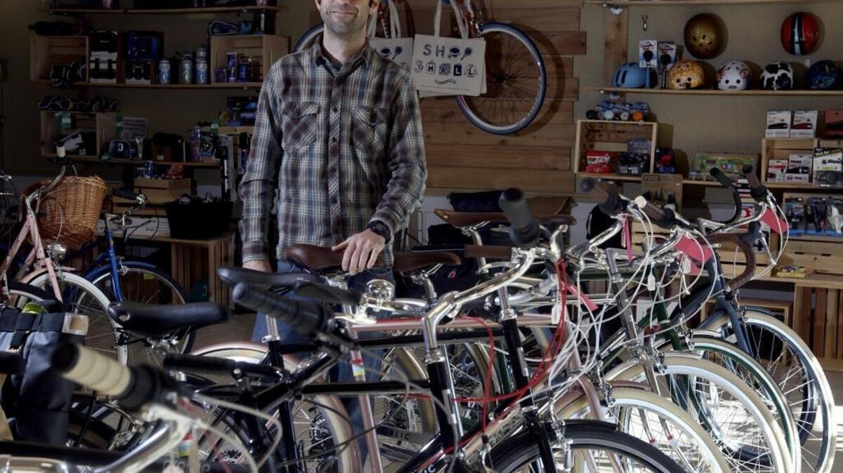 David Spaulding stands in his downtown Kennewick business, Liberation Bike Shop. Spaulding is converting the small business into a nonprofit, Wheelhouse Community Bike Shop, that will open early next year.