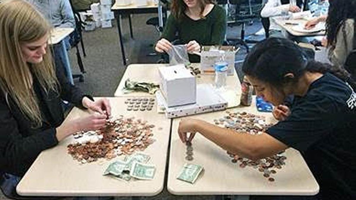 Members of the Hanford High School Key Club count “Pennies for Patients” donations. The student body donated a total of $2,250.