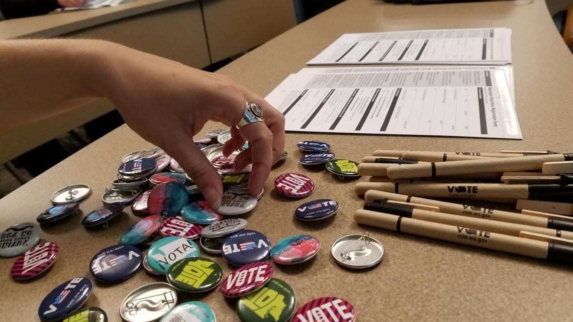 A stack of pins, pens and voter registration forms were available Tuesday to students in Gary Bullert’s American Government class.