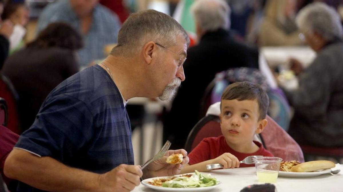 Preschooler Tanner Weyh, 4, looks Friday at his grandfather Steve Isley, of Kennewick, during the annual grandparents luncheon at St. Joseph’s Catholic School in Kennewick. Hosted by the eighth-grade class, the fundraiser helps support events and provides an opportunity for grandparents to spend time with their grandchildren.