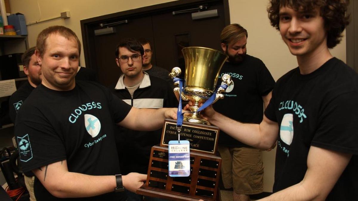 Columbia Basin College students Keith Thornhill, left, and Levi Staley hold the first-place trophy their cyber-defense team won at a recent regional competition. The team will soon head to the national competition to compete against nine other teams.