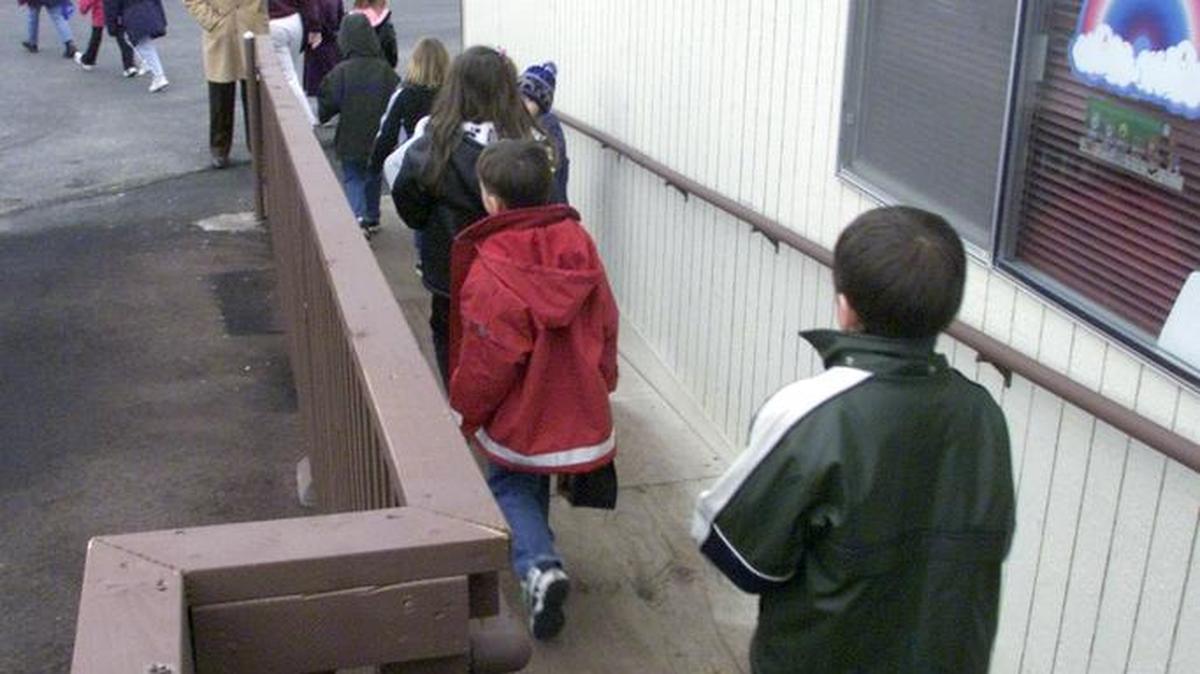 First-graders at Wiley Elementary School in West Richland leave their temporary classroom for lunch in this photo from 2001. The Richland School District is planning to add a 12-classroom modular building at Wiley and at Richland’s two high schools to ease crowding.