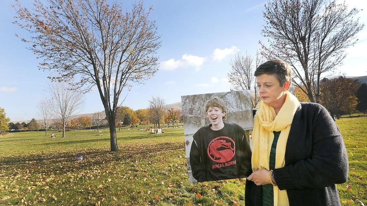 Kimberly Starr of Prosser holds a family photo of her son, Tom Mears, near a tree in the Prosser Cemetery where she plans to bury his ashes next spring. The 17-year-old Prosser High student was one of two classmates at the rural school to commit suicide this year. Starr picked the site of her son’s final resting place because of his fondness for sitting under trees.