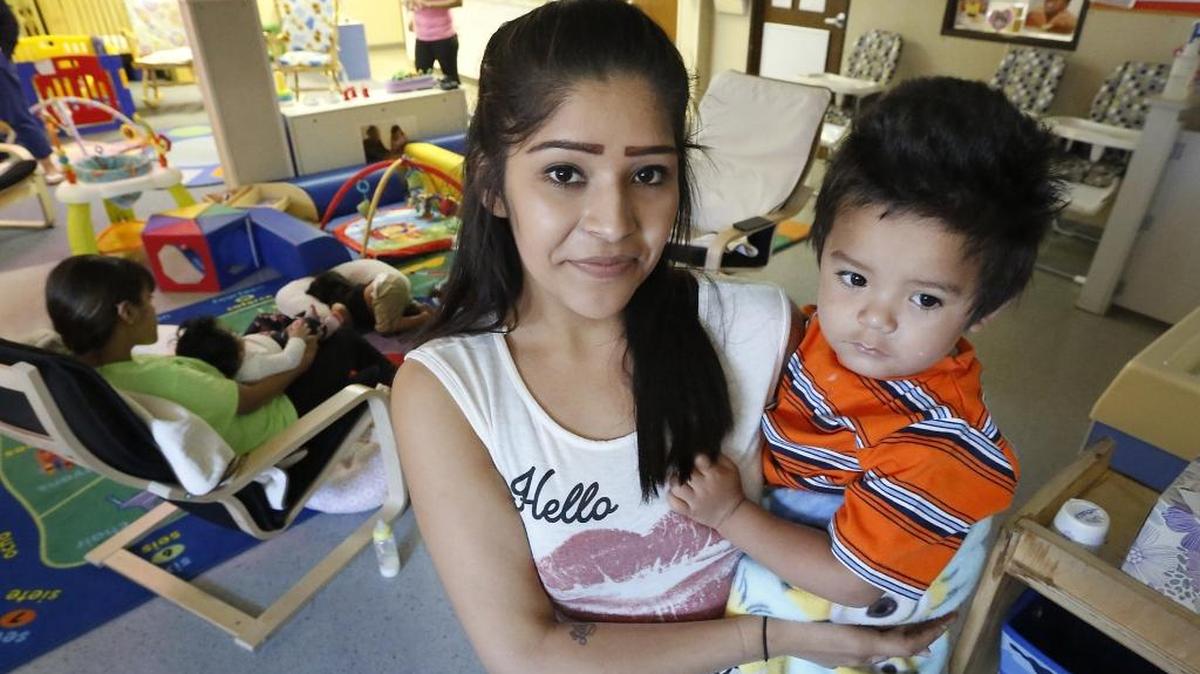 Roxana Martinez, who was living in the Tri-City Union Gospel Mission earlier this spring, is now living on her own and is set to graduate June 10 from New Horizons High School. She holds one of her two children, Damien, 2, in the Pasco school’s daycare.
