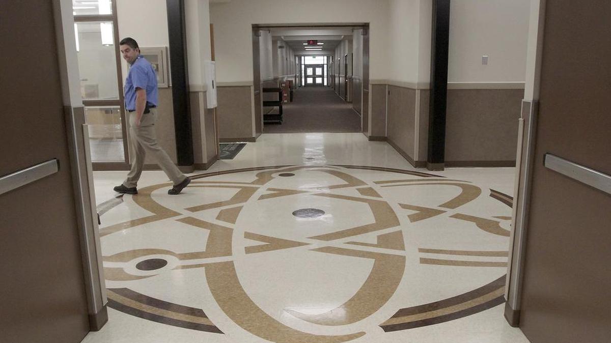 
Assistant Principal K.C. Flynn walks past a floor design in the new Marie Curie STEM Elementary School in Pasco.
