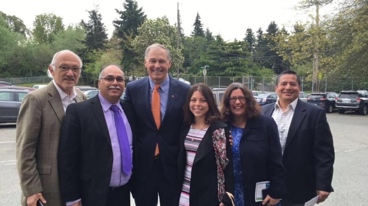 Pasco High Principal Raul Sital, Ricardo Sanchez with the Commission on Hispanic Affairs, Maia Espinoza with the Center for Latino Leadership, Nora Coronado with the Hispanic commission, and Quincy school board member Alex Ybarra stand with Gov. Jay Inslee after he signed House Bill 1445.