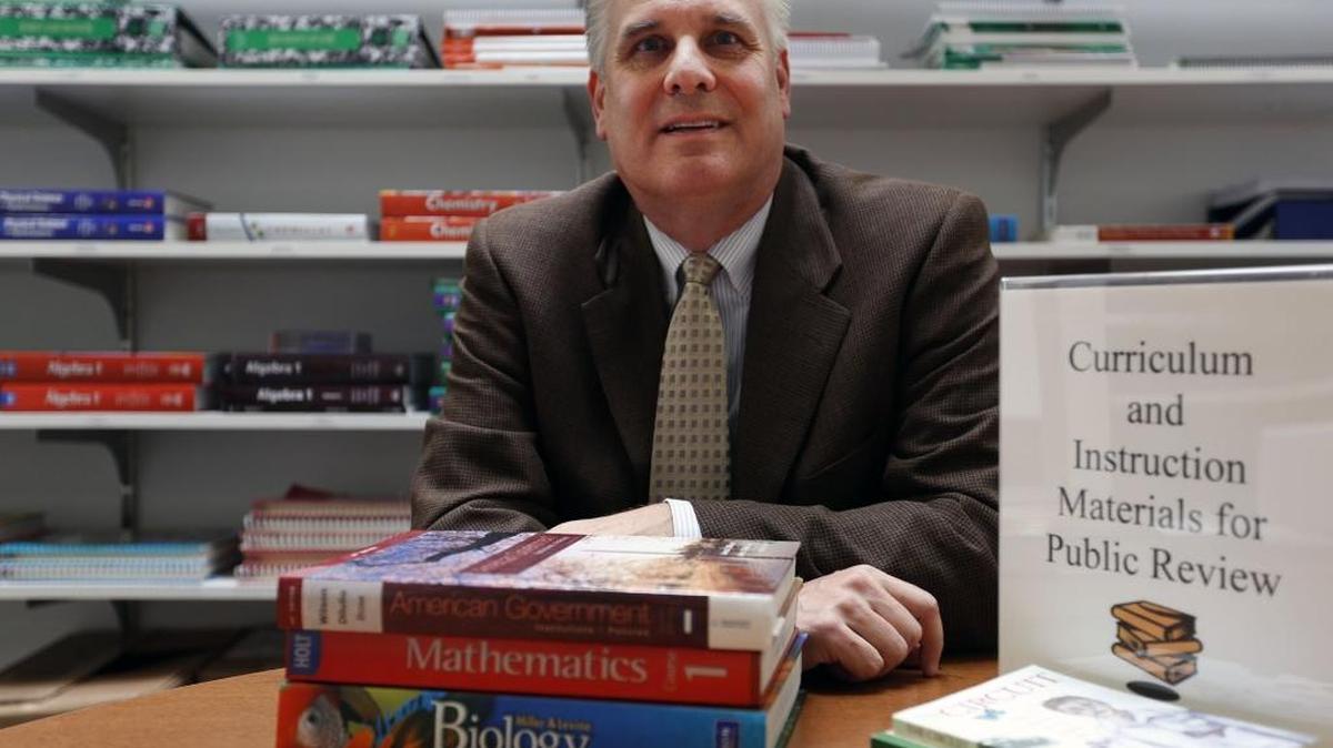 
Chuck Lybeck, Kennewick School District assistant superintendent, shows some of the textbooks in the district’s curriculum library. Materials used in the schools, including those up for review, are available for students, teachers and the general public at the district offices in Kennewick.
