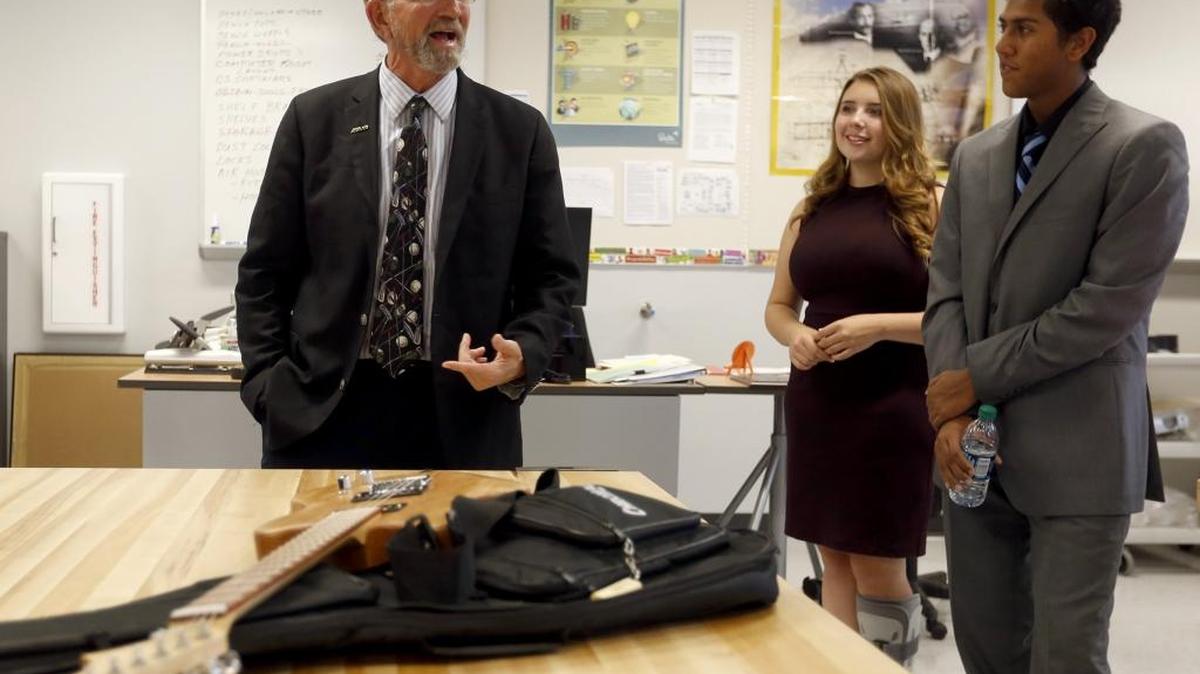 
Randy Dorn, superintendent of public instruction for Washington State, left, takes a look at a guitar made in an engineering class with Delta High School juniors Emily Peite, center, and Sanjay Philip Wednesday during an open house and dedication ceremony at the new school in Pasco. See a video at www.tricityherald.com/video.
