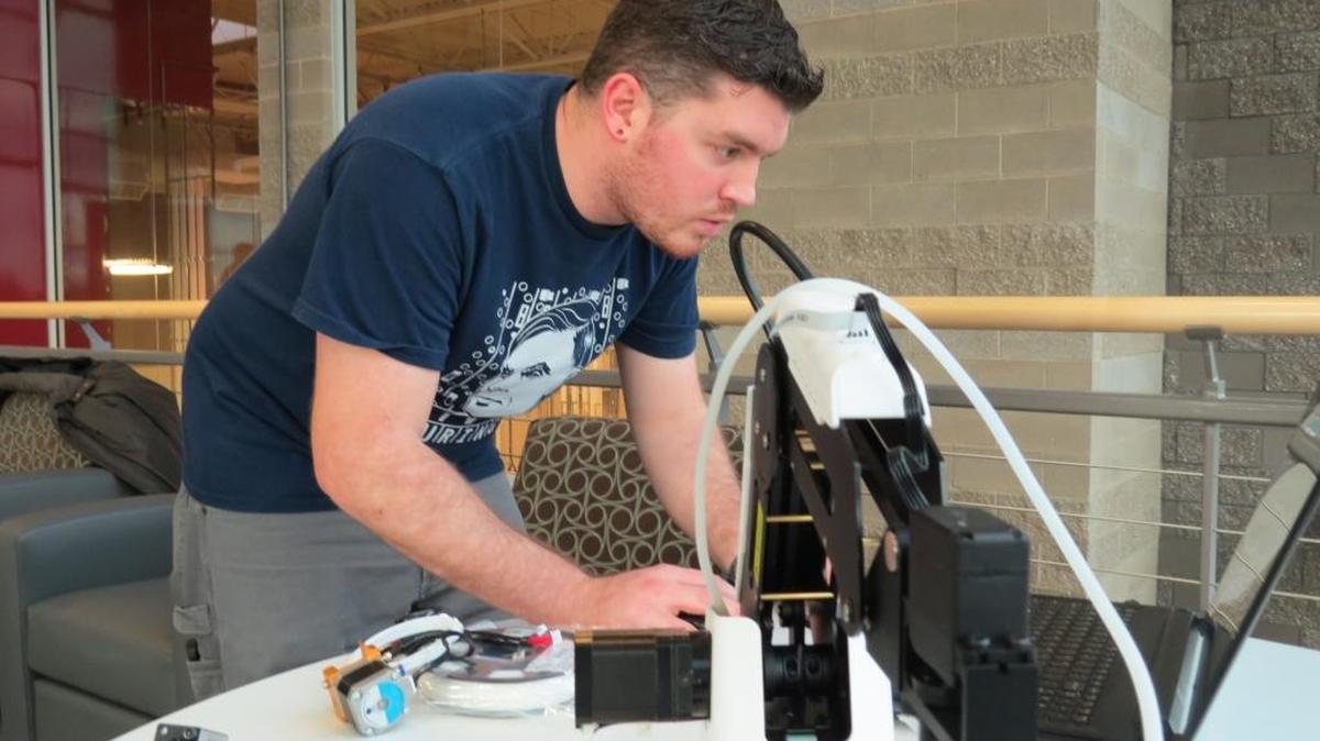 Eric Loeffler, a mechanical engineering major, demonstrated a robot prior to the ceremony.